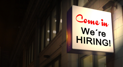 Am image showing a lightened up sign that reads 'Come in we're hiring'