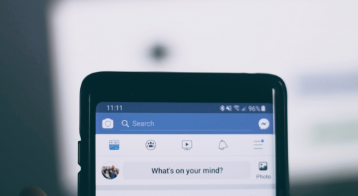 An image showing a phone with the Facebook app open.