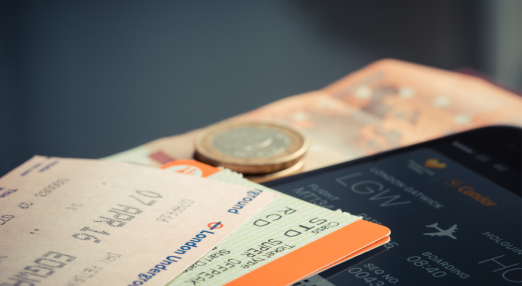 An image showing plane tickets and money