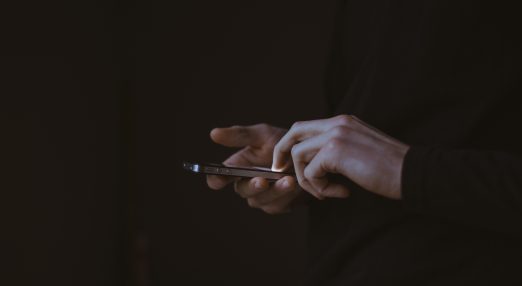An image showing the hands of someone on their phone