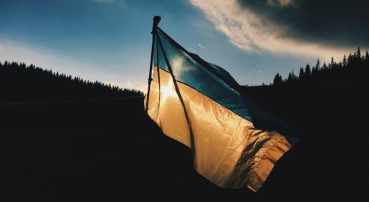Ukrainian flag with a background showing a forest.