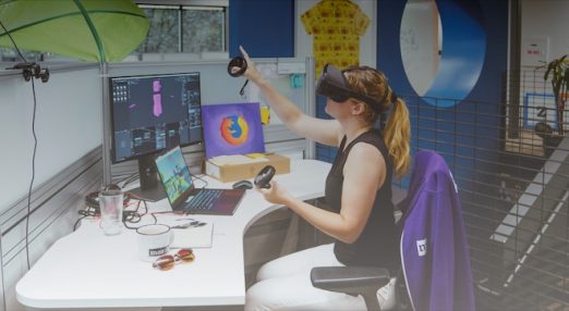 A person trying out VR glasses in an office enviornment