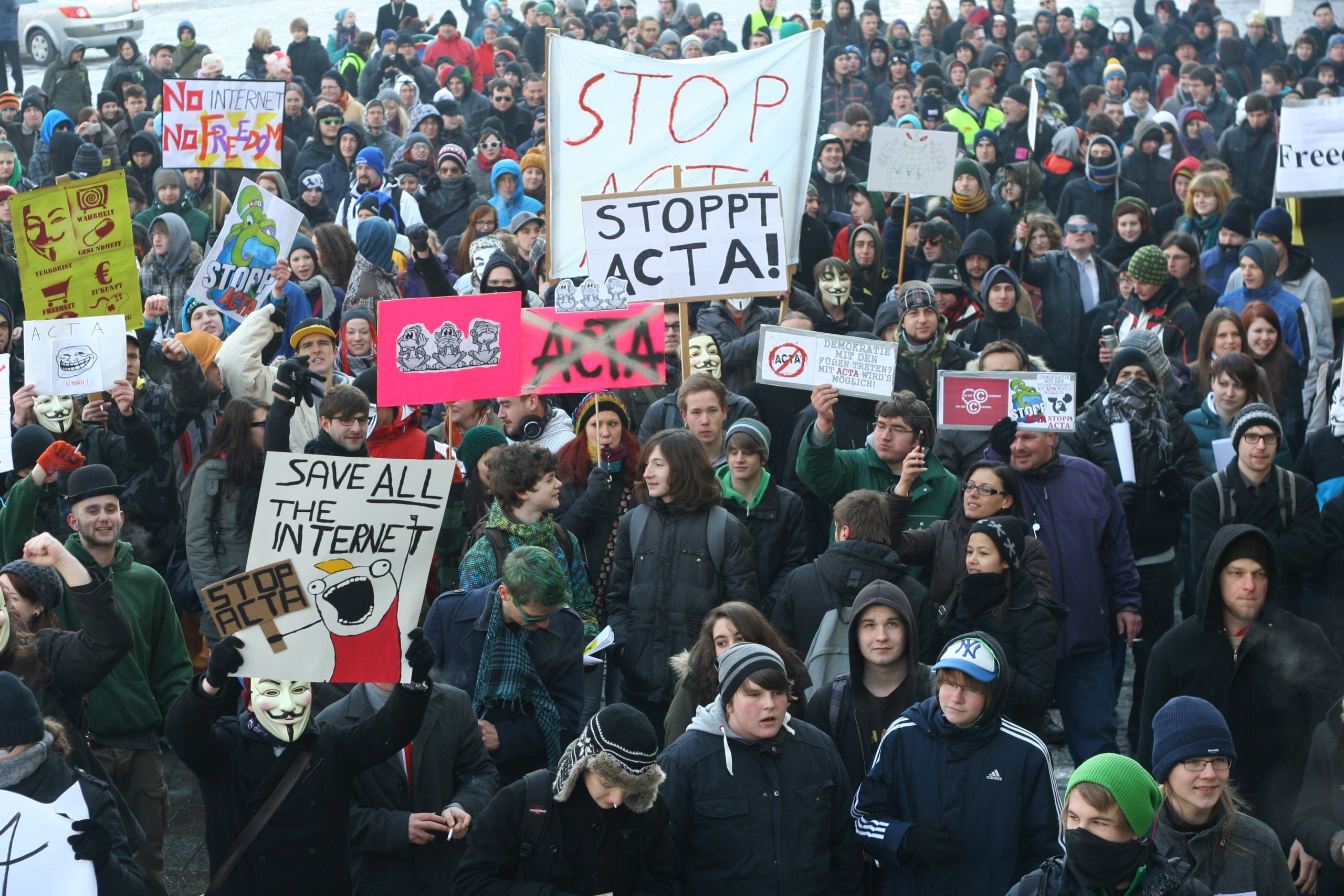 Group of activists protesting, "stop acta"