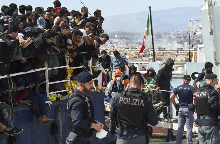 Migrants disembark from a ship in the Sicilian port of Catania, April 2023