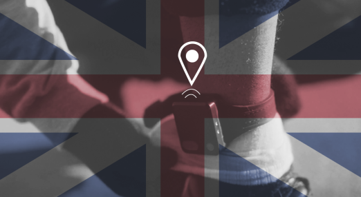 The flag of the United Kingdom, in the background an ankle with a GPS