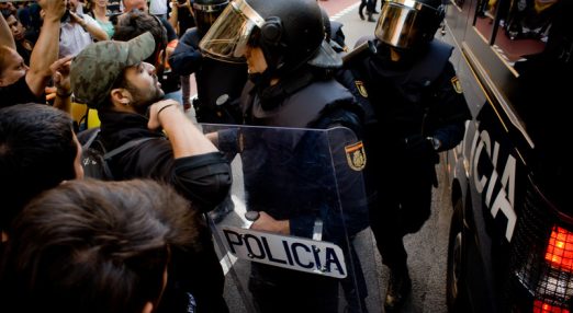 Catalan Pro-independence protester confronts a Spanish police Guardia officer during a protest near the Catalan Economy Ministry after Spain's Guardia Civil police arrested top Catalan government officials ahead of an independence referendum on 1st October in Barcelona, Spain, 20 September 2017.