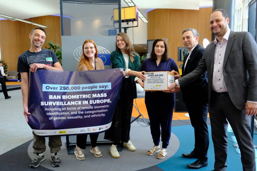 Activists handling the signatures of over 250,000 people to MEPs for a ban on biometric mass surveillance