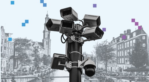 Multiple security cameras positioned on a pole, monitoring activity in the city of Amsterdam